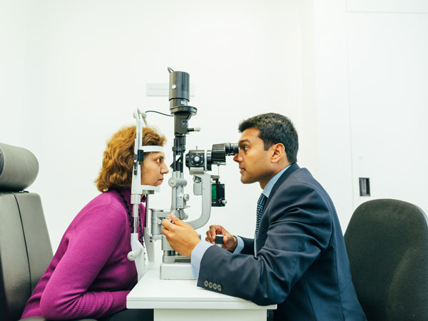 Woman having her eye's checked by an eye surgeon