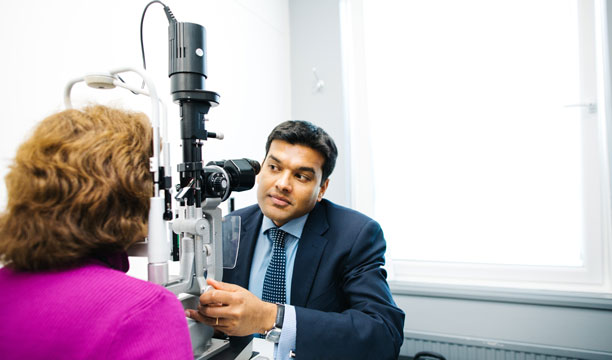Eye Surgeon examining a patient's eye at a consultation for cataract surgery